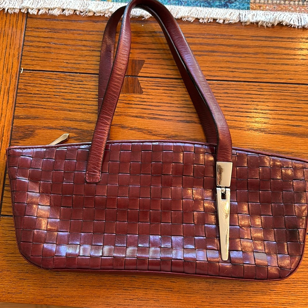 Woven leather clutch with stainless steel detail